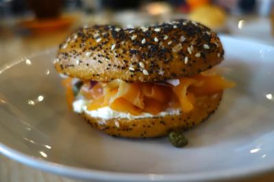 Photo of everything bagel stuffed with cream cheese, lox and capers.