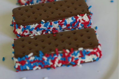 Photo of ice cream sandwich with red, white and blue sprinkles.