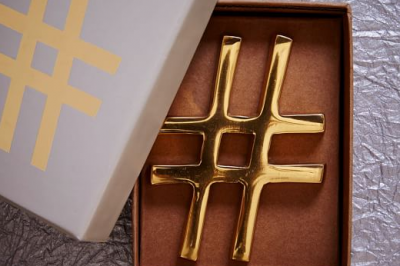 Photo of West Elm brass hashtag paper weight.